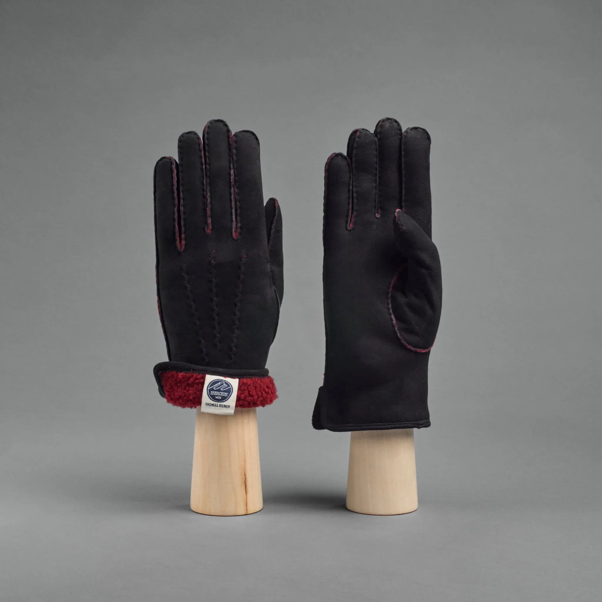 Ladies Gloves from Black Curly Lambskin lined with red Shearling